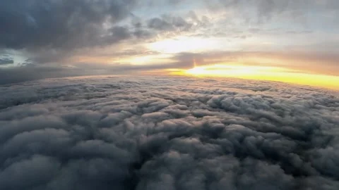 Falling into the clouds from an airplane at sunset, above the clouds Stock Footage