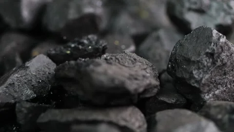 Falling coal fragments hit each other in slow motion, creating splinters. P.. Stock Footage 297907402