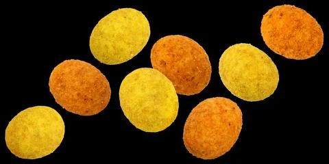 Falling coated peanuts isolated on black background Stock Photos