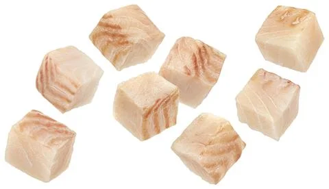 Falling cod fish fillet cubes isolated on white background Stock Photos