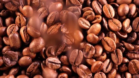 Falling coffee beans. Coffee beans pour into a pile. close up of roasted coffee Stock Footage 256145364