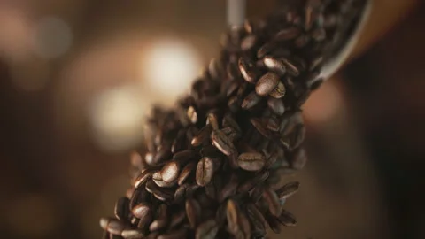 Falling coffee beans in super slow motion in 4K Stock Footage 99915499