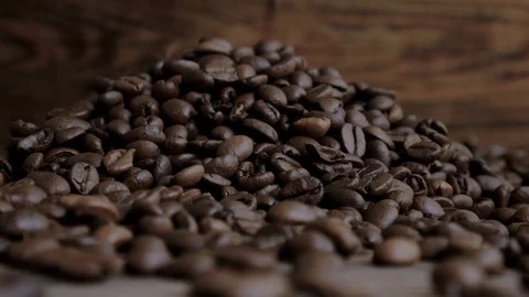 Falling coffee beans on wooden background Stock Footage 107886941