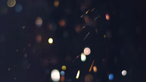 Falling coins, glitter or bokeh on black background Stock Footage 124043039
