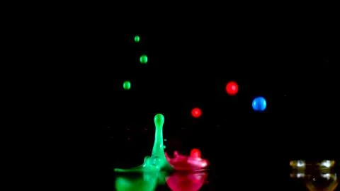 Falling colored drops from a small height Stock Photos