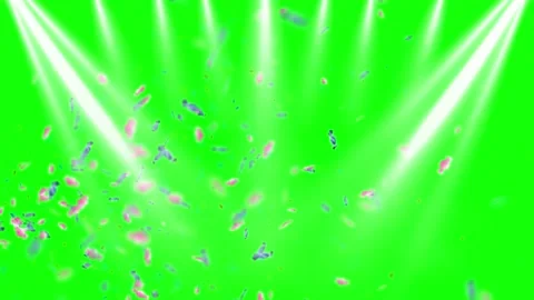 Falling Colorful Confetti Particles with Bright Stage Spotlights on a Green Stock Footage 338436333