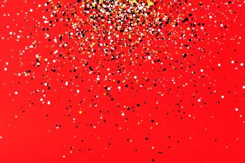 Falling confetti on red background Stock Photos