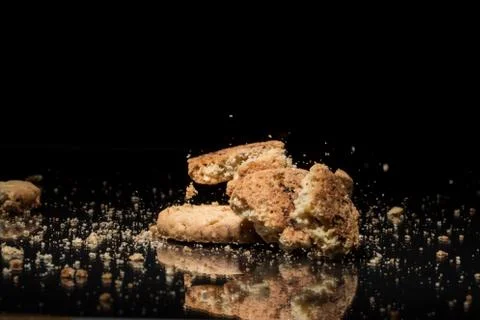 Falling Cookies On Black Background Stock Photos