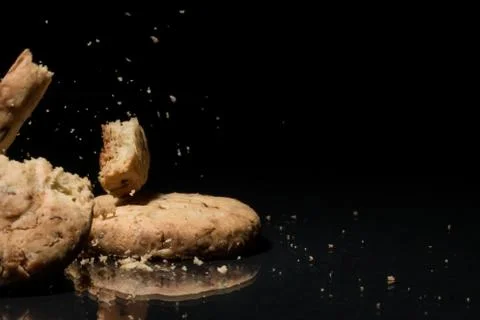 Falling Cookies On Black Background Stock Photos
