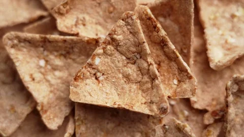 Falling crispy buckwheat nachos or triangular tortilla chips Stock Footage 332732318