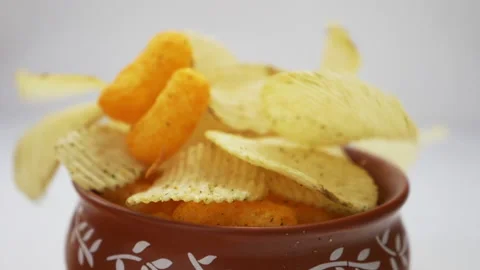 Falling crispy golden potato chips in slow motion Stock Footage 139811295