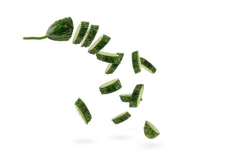 Falling cucumber slices on white isolated background. The cucumber scatters. Cut Stock Photos