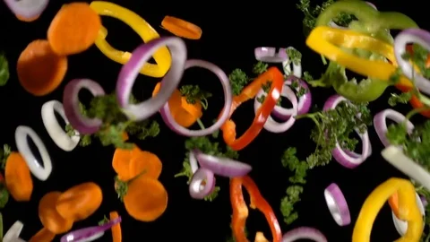 Falling cuts of plenty colorful vegetables, slow motion Stock Footage