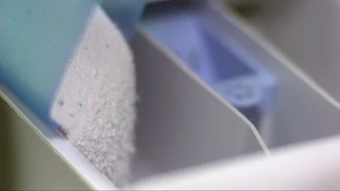 Falling detergent into washing machine bin in slow motion Stock Footage 256940547