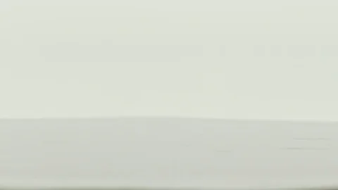 Falling dice in super slow motion turning against a white grey background. Stock Footage 71015517