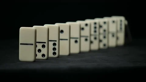 Falling domino elements - domino effect on black Stock Footage 153198279
