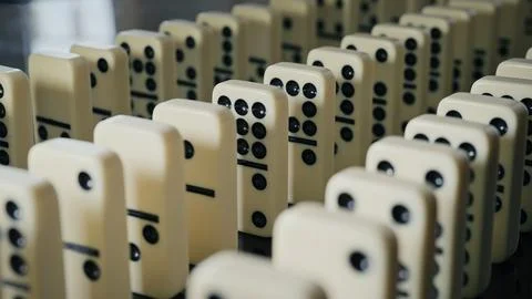 Falling domino pieces trigger a continuous chain reaction. Symbol of cause .. Foto stock