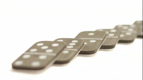 Falling dominoes with rack focus on white Stock Footage 526426