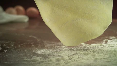 Falling dough on the kitchen table Stock Footage 256936866