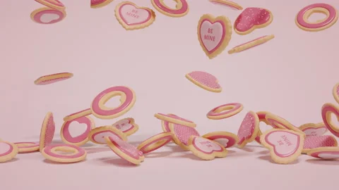 Falling down pink colored sugar cookies on light pink surface Видео 168839734