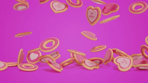 Falling down pink colored sugar cookies on bright purple surface Видео 168839789