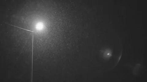 Falling down in real time snowflakes around streetlight at night, calm small Stock Footage 75249127