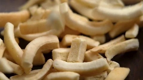 Falling dried dehydrated coconut pieces into wooden bowl Stock Footage 302817683