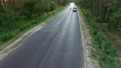 Falling of drone after crashing into pine tree over country roadway Stock Footage 100140897