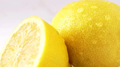 Falling Drops On Closeup Lemon On A White Background Stock Footage 52126412
