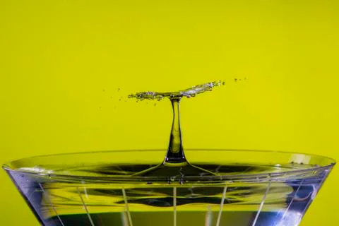 Falling Drops Collide over Martini Glass Foto stock