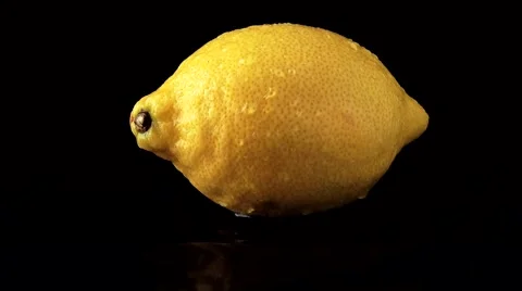 Falling Drops On Lemon On A Black Background Stock Footage 52180852