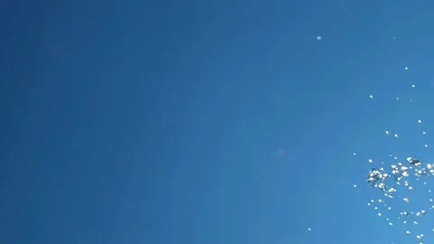 Falling drops of water falling down create splashes against background of blue Stock Footage 133765966