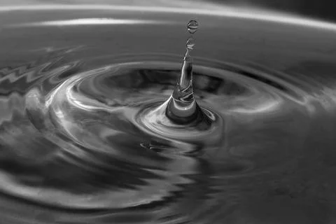 Falling drops in water Stock Photos