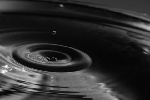 Falling drops in water Stock Photos