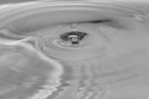 Falling drops in water Stock Photos