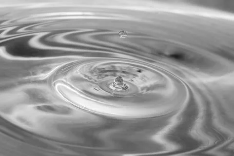 Falling drops in water Stock Photos