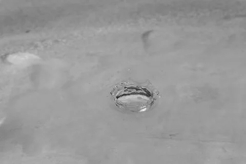 Falling drops in water Stock Photos