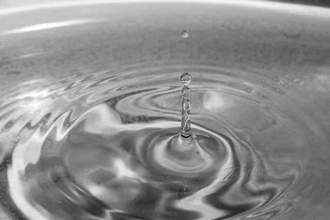Falling drops in water Stock Photos