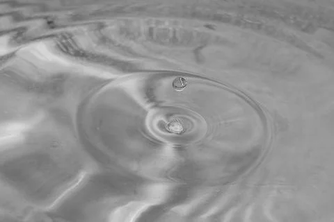 Falling drops in water Stock Photos
