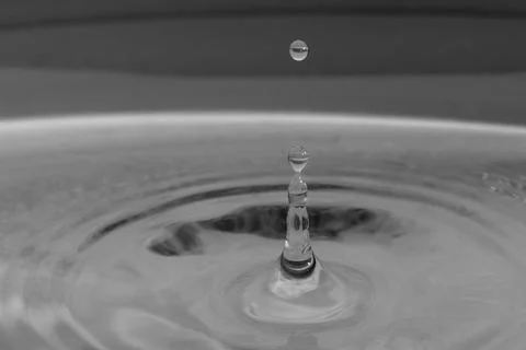 Falling drops in water Stock Photos