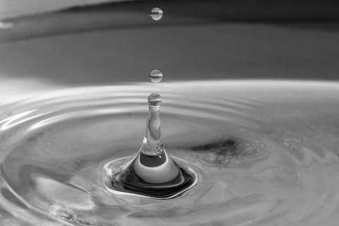 Falling drops in water Stock Photos