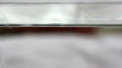 Falling drops on water surface Stock Footage 21879534