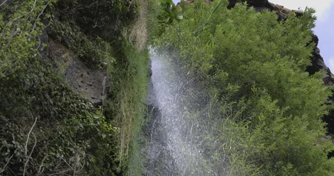 Falling drops of water from a waterfall, 4K slomo Stock Footage 246390687
