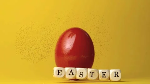 Falling EASTER cubes sliding down red egg, causing particle spray and settling Video stock 330380094
