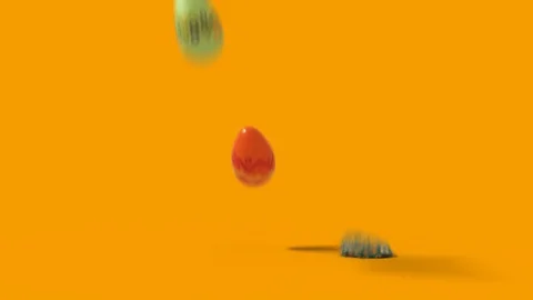 Falling easter eggs on a uniform background Stock Footage 126233379