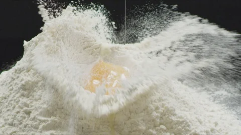 Falling Egg into flour Stock Footage