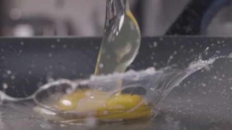 Falling of the egg into the frying pan. Slow motion Video stock 97909396