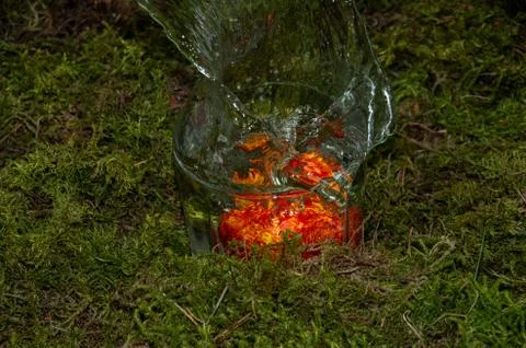 Falling egg in a glass of water for Easter Stock Photos