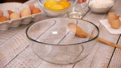 Falling egg yolks slow motion - prepare homemade food in the kitchen Stock Footage 104463801