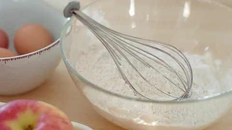 Falling eggs into flour. Sun light slowmotion Stock Footage 70942642